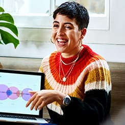 Person laughing showing laptop
