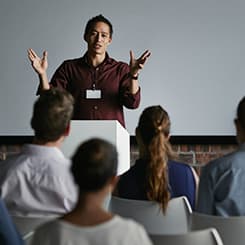 Person standing at front of classroom teaching