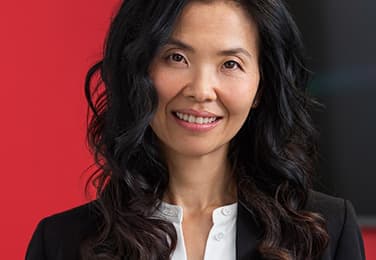 Heran Jung headshot with red background
